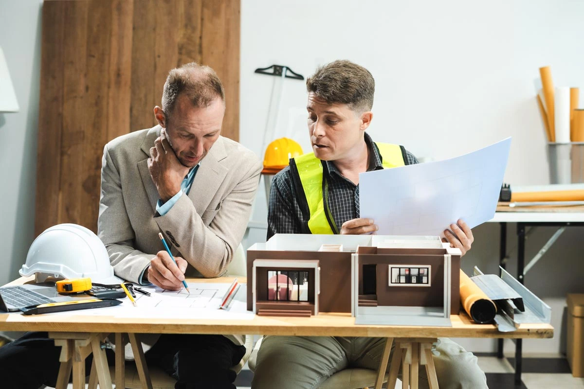 Architect and client discussing house plans designs