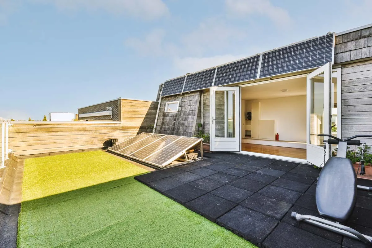 Modern Home Showcasing Large Windows For Natural Light And Solar Panels For Sustainable Energy 