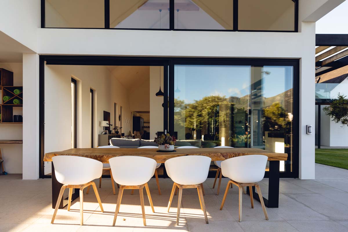 Seamless Indoor-outdoor Living Space With A Patio Featuring Comfortable Outdoor Furniture And An Easy Transition From The House