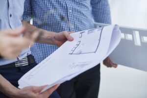 Commercial Builder And Architect Discussing Building Plan